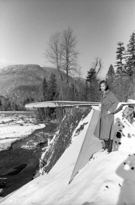 Iona Campagnolo on river bank by damaged bridge near Moricetown