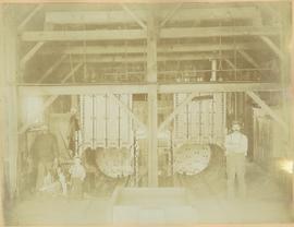 Men and Boy standing next to dear kill at cannery retorts