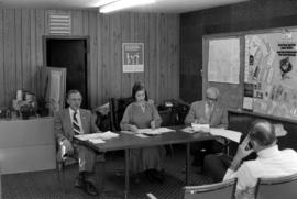 Iona Campagnolo at a table with Vic Walton and John Blake in meeting with disaster officials in Terrace