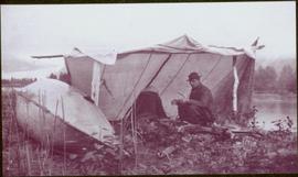 Taku River Survey - Man sitting under tent structure
