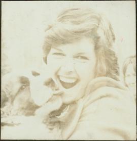Iona Campagnolo being kissed by a twelve week St. Bernard puppy at the Kispiox Rodeo