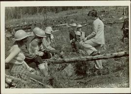 Iona Campagnolo talks to group of eight unidentified women in hardhats inside a clearcut