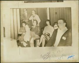 Group shot of four unidentified women, three unidentified men, and M.P. Iona Campagnolo inside a ...