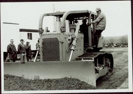 Two unidentified men operating a bulldozer at the sodturning ceremony for the opening of the Prin...