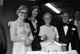 Group photo with Iona Campagnolo and decorative cake at grand opening of Grand Lodge for Independent Order of Odd Fellows