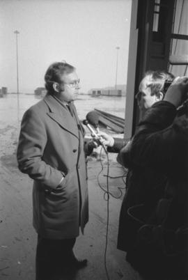 Otto Lang talking to reporter with microphone during visit to Prince Rupert Fairview Cargo Terminal