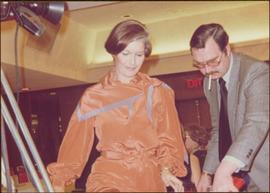 Minister Iona Campagnolo looks down beside an unidentified man, Prince George, ca. 1977
