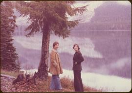 Minister Iona Campagnolo and Peter Jones overlooking a lake on Highway 37, 1977