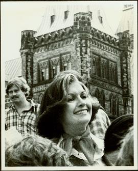 Close View of Minister Iona Campagnolo standing in group with Parliament buildings behind her, Ottawa, 1977