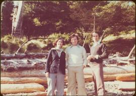 Minister Iona Campagnolo poses in front of beached driftwood with Peter Jones and an unidentified man, summer 1977