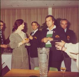 Iona Campagnolo speaks with several unidentified men wearing Team Canada jackets after the International Ice Hockey Federation World Championships, 1978