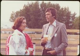 Commonwealth Games, Edmonton 1978 - Iona Campagnolo stands drinking with unidentified man