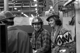 Iona Campagnolo and man with hard hat and ear protection at sawmill owned by Rim Forest Products ...