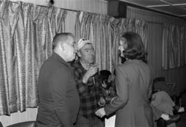 Iona Campagnolo speaking with men, possibly at Kitimat Elks Lodge