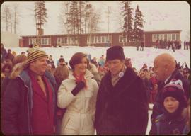 Stanley Ronald Basford, Iona Campagnolo, and Prime Minister Pierre Trudeau in front of an outdoor crowd at the Northern BC Winter Games, Prince George, Winter 1978
