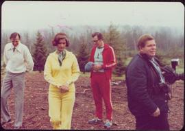 Minister Iona Campagnolo wears a jogging suit while standing outside with two unidentified men an...