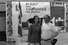 Iona Campagnolo posing with man in front of podium for her Liberal re-election campaign