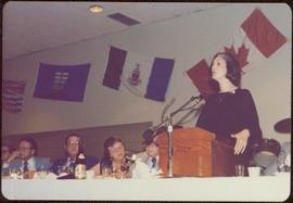 Canada Winter Games, Brandon, MB - Iona Campagnolo speaks at podium set on banquet table, unident...