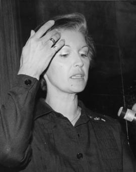 Iona Campagnolo speaking at microphone and wearing pin for 1980 Olympics in Liberal publicity image