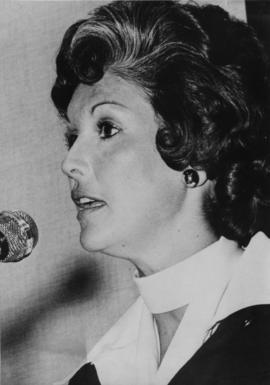 Iona Campagnolo at microphone in Liberal publicity image