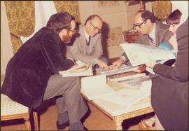 Paris Press Conference - Roger Jackson, Iona Campagnolo, and three unidentified others consult documents at coffee table