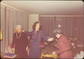 Iona Campagnolo standing in living room with unidentified woman and Thérèse Casgrain, Quebecois feminist and former senator