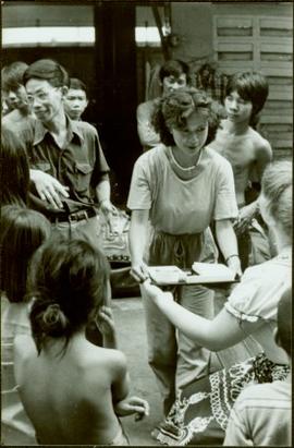 CUSO Mission, North-eastern Thailand - Unidentified woman offers a tray to another woman in group