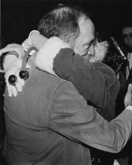 Prime Minister Pierre Trudeau hugging Iona Campagnolo dressed as Santa Claus