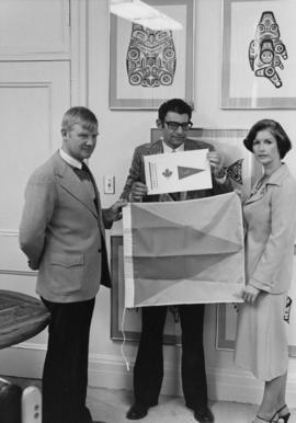 Iona Campagnolo with two men possibly holding coast guard ensign