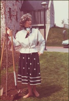 Iona Campagnolo, shoeless, planting a tree in Cambridge, Ontario, 1983
