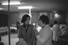 Iona Campagnolo speaking with woman, possibly at seniors centre