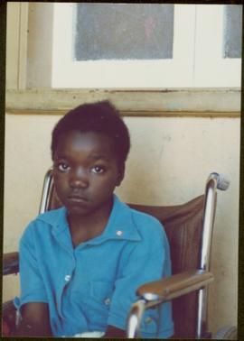 CUSO Mission in Angola - Unidentified child seated in a wheelchair