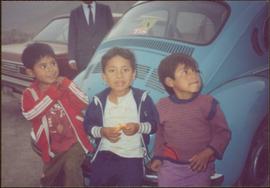 W.H.O. Trip, Ayacucho, Peru - Three unidentified children in front of a blue Volkswagen beetle