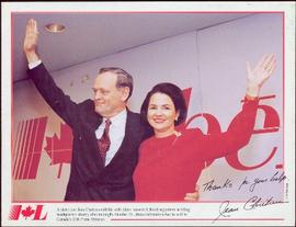 Commemorative photograph - Jean and Aline Chrétien waving in front of a red Liberal sign