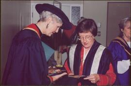 Honourary Doctor of Laws, Brock University - Iona Campagnolo examining the university crest with unidentified woman