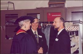 Honourary Doctor of Laws, Brock University - Iona Campagnolo in regalia, speaking with two unidentified men