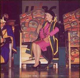 Iona Campagnolo seated onstage on the Chancellor’s carved ceremonial chair, in full Chancellor’s ...