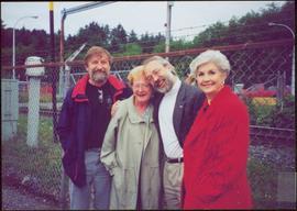 Dennis Macknak, Addie Milewski, Clive Keen and Iona Campagnolo stand together in front of a barbed wire fence