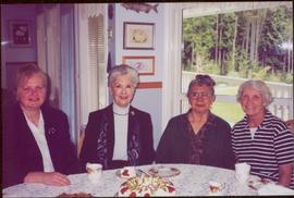 Lieutenant Governor Iona Campagnolo sitting with three women around a table set for tea at Missio...