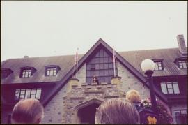 Unidentified man playing bagpipes on the balcony of Government House in Victoria, BC