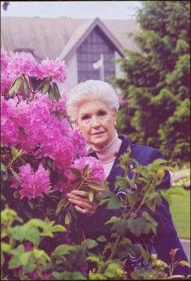 Portrait of Lieutenant Governor Iona Campagnolo standing beside a pink rhododendron with Governme...