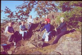 Five gardeners and Iona Campagnolo sitting on rocky outcrop in Terrace Gardens, Government House,...