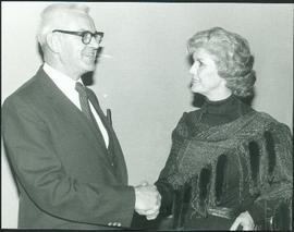 Iona Campagnolo shakes hands with an unidentified man