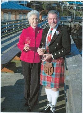 Iona Campagnolo standing on a dock with an unidentified man in formal kilted attire