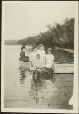 Children with Elderly Woman in Boat