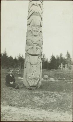 W.E. Collison at totem pole in Masset, Queen Charlotte Islands, BC