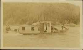 Crew of unidentified men poling a boat up Nass River, BC