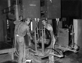 Fernand Lanteigne and Steve Slauko with strapping machine at Clinton Creek mine