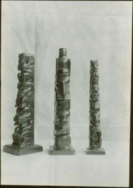 Three argillite totem poles