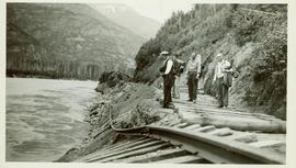 Four men trekking along the CNR line to view the disappearing track along the Skeena River
